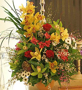 Wedding gift flowers arrangement made of  cymbidium orchids, roses, santini, alstroemeria, genista